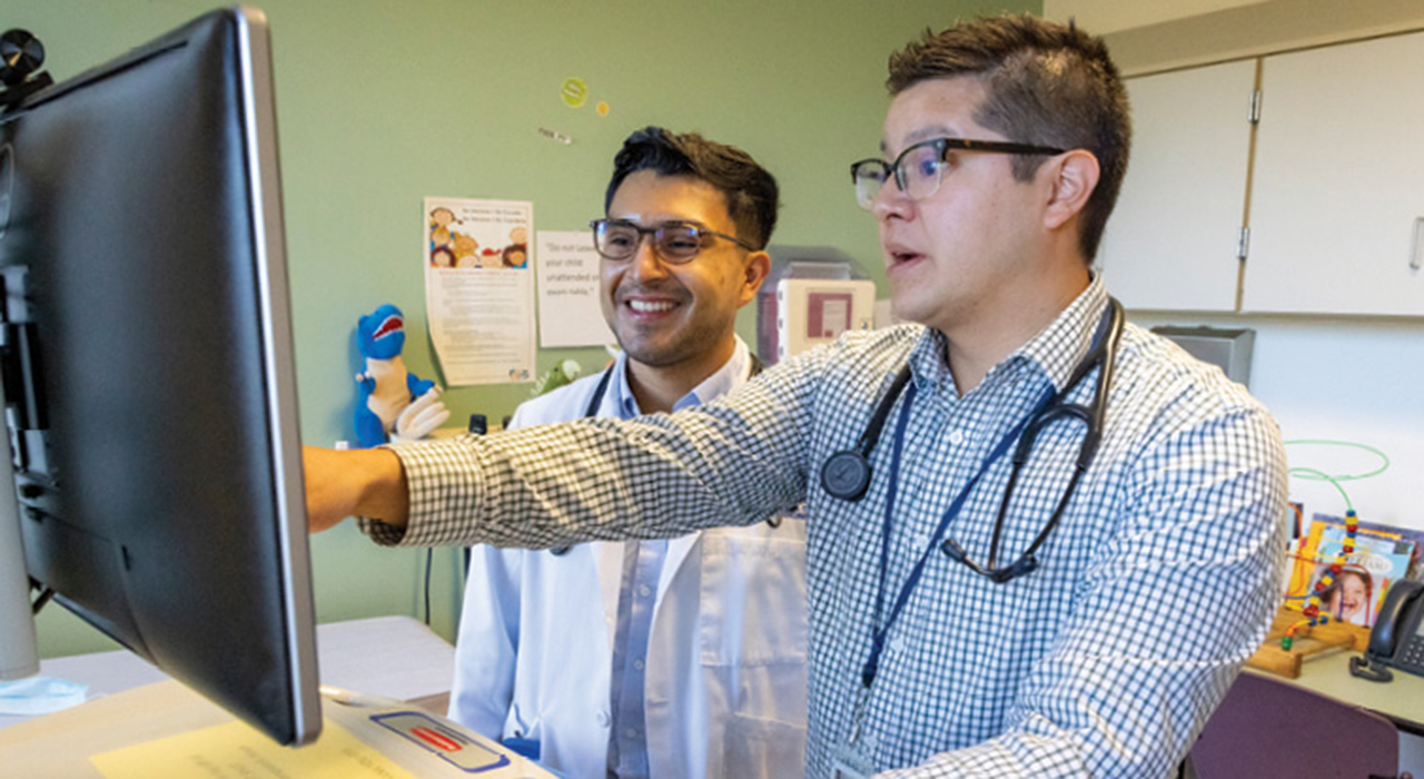 UC Davis Health pediatrician Sean Muñoz, pictured right, assigned to the Sacramento County Health Center, trains medical student Andrés Maldondo.